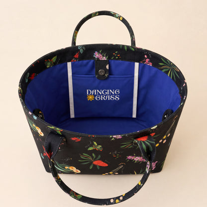 Australian Floral-patterned bag with a blue interior and 'Dancing Grass' logo on a beige background