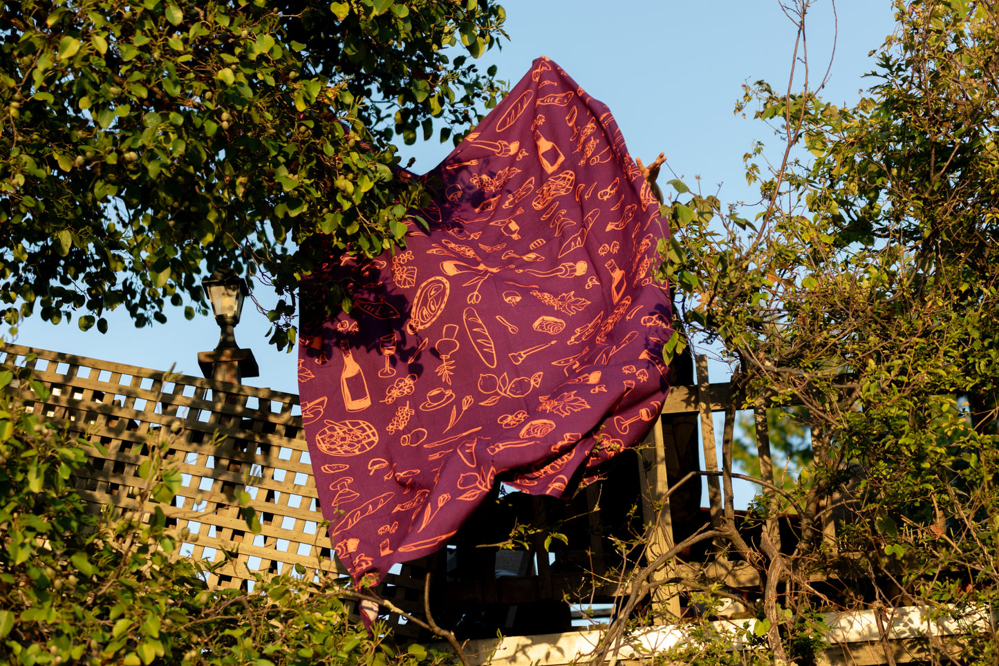 Purple tablecloth billowing softly in the gentle breeze, evoking a sense of calm and elegance