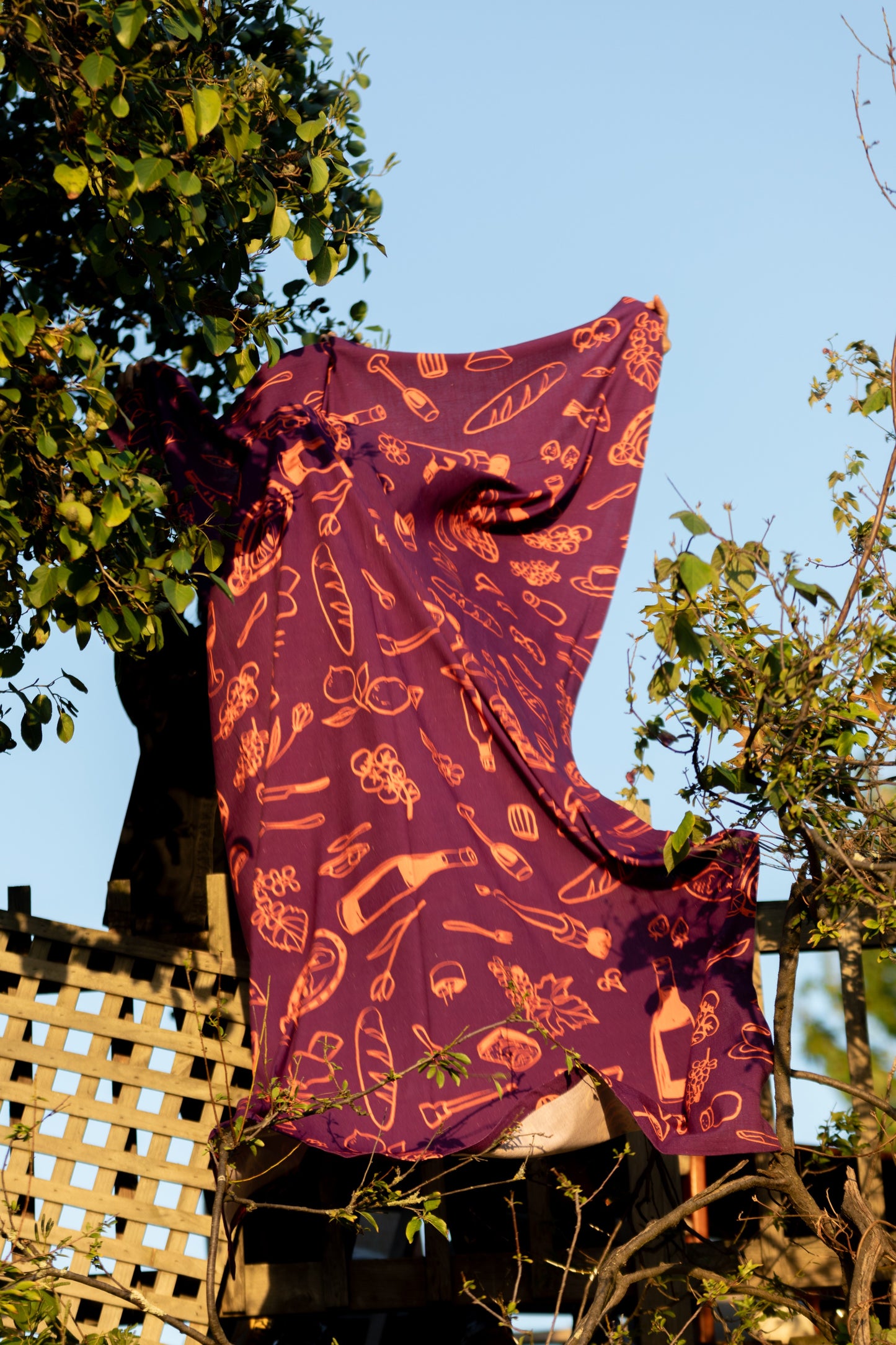 Purple tablecloth fluttering elegantly in the gentle wind