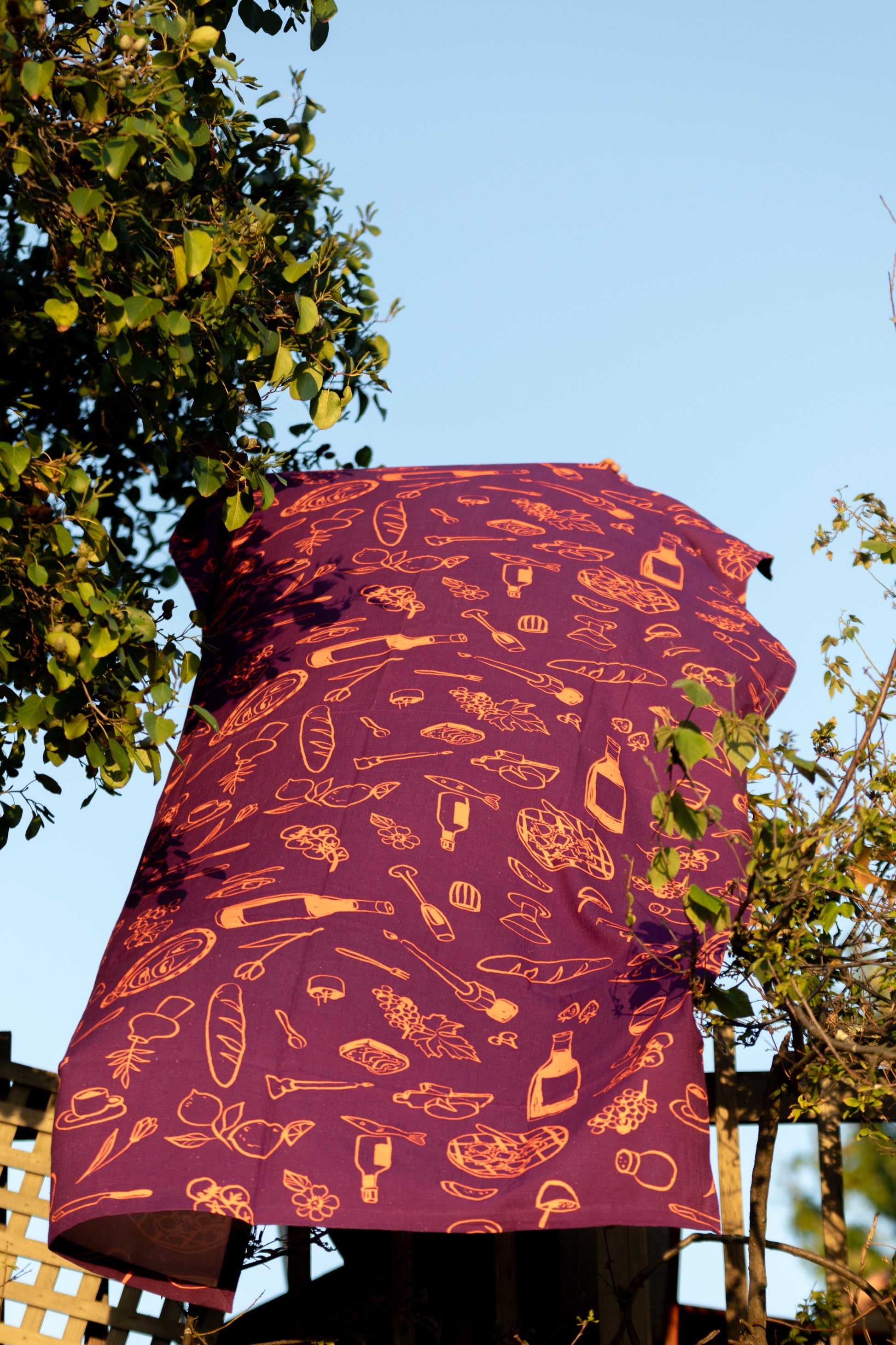 Purple tablecloth fluttering gracefully in the breeze outside in the wind