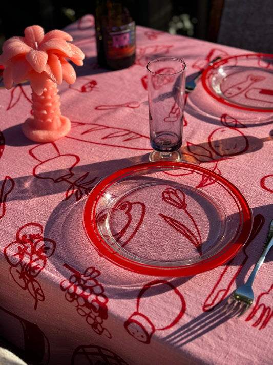 pink tablecloth with red plates 