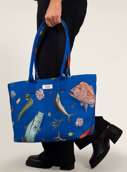 Model walking with the Australian Fish Dancing Grass bag carried in hand