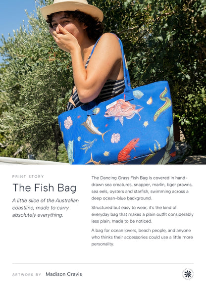 The Fish Bag print story: woman carrying the Australian Fish Dancing Grass bag outdoors by an olive tree